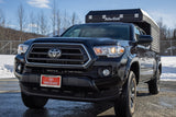 This black Toyota Tacoma with an Alu-Cab truck camper makes a rugged RV rental.