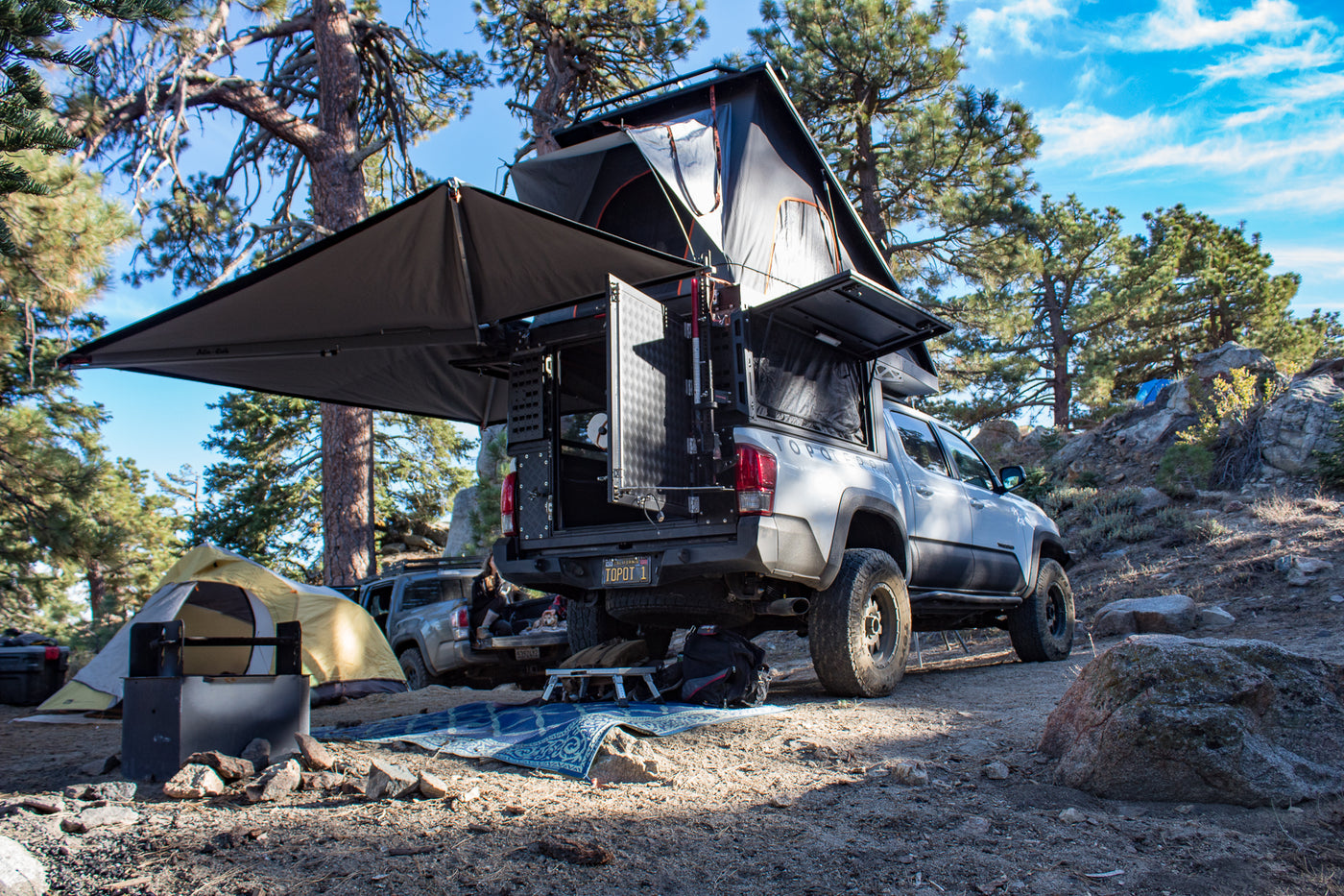 Adventure-ready overlanding setup, a unique RV rental alternative, with rooftop tent & awning in a sunny forest. — photo 6