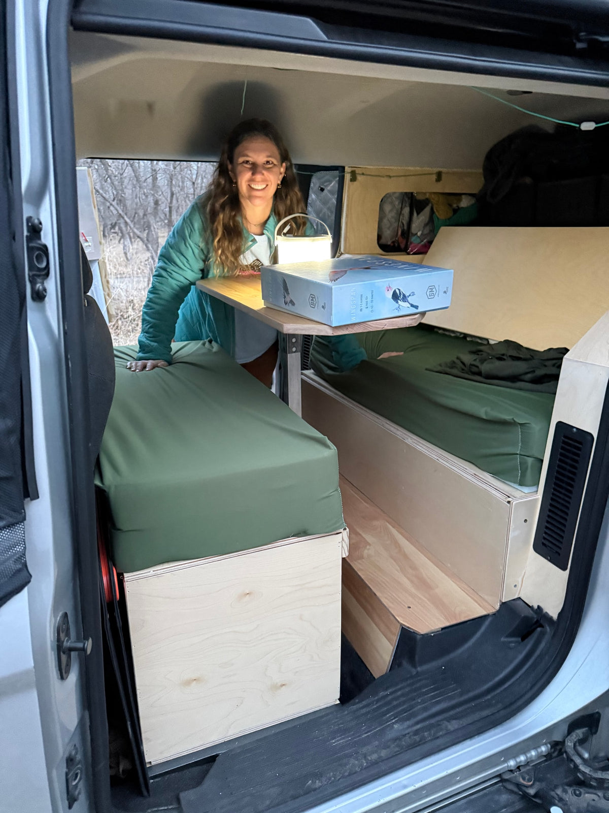  ready for winter adventure.|Compact RV rental: Custom camper van interior with a bed — photo 5