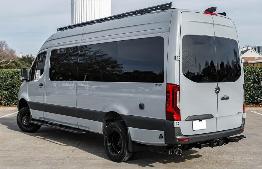 This sleek gray Mercedes-Benz Sprinter conversion van, ideal for rv rental, features a roof rack & tow hitch. — photo 3