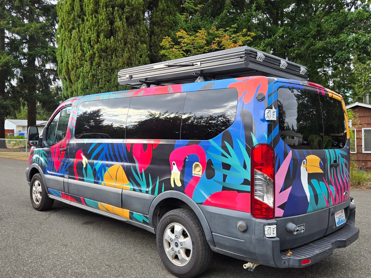  is perfect for your next camping adventure.|Hard-shell rooftop tent open on a brightly wrapped vehicle — photo 15
