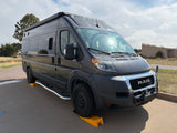 Dark gray Entegra RAM ProMaster RV rental parked on leveling blocks.