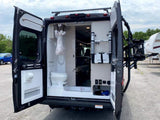 This **rv rental** camper van, viewed from the rear with open doors, showcases its compact bathroom with toilet/shower, interior, and bike rack.