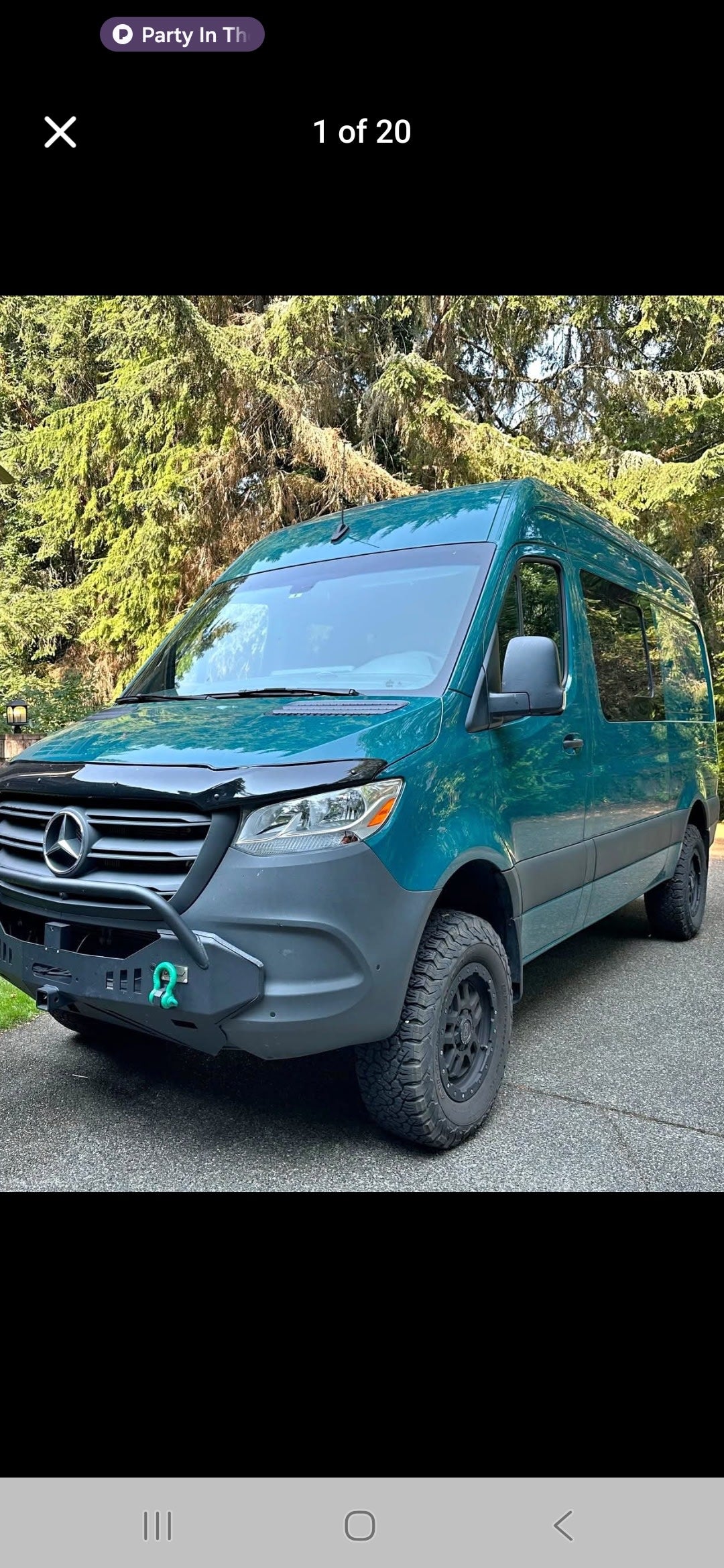 Explore with this teal Mercedes Sprinter van RV rental, equipped with rugged tires & custom bumper for adventure.