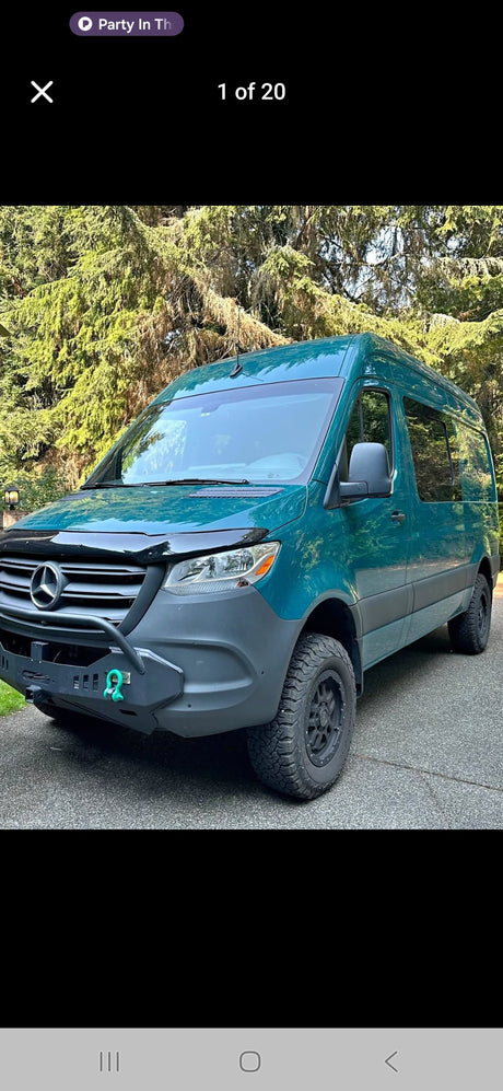 Explore with this teal Mercedes Sprinter van RV rental, equipped with rugged tires & custom bumper for adventure.