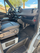 View inside a clean RV rental van, showing the passenger seat, dashboard, and durable floor mats. Ideal for your next road trip.