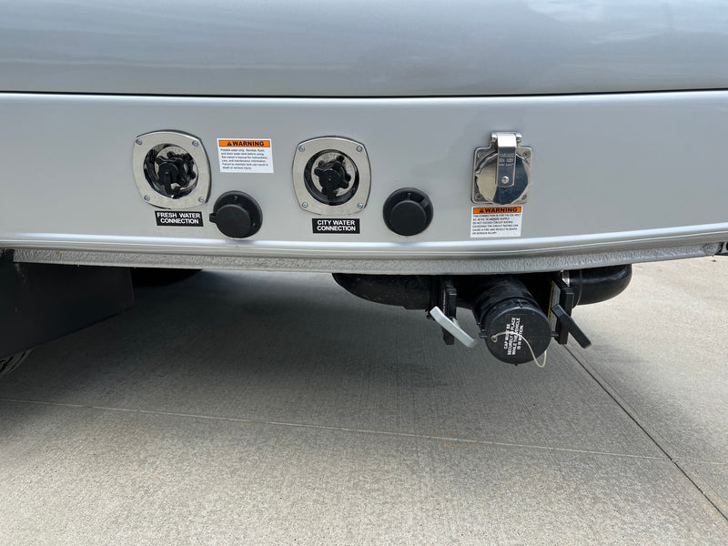 An RV rental's exterior utility panel featuring fresh/city water, 30A power, and sewer connections for easy hookup. — photo 16