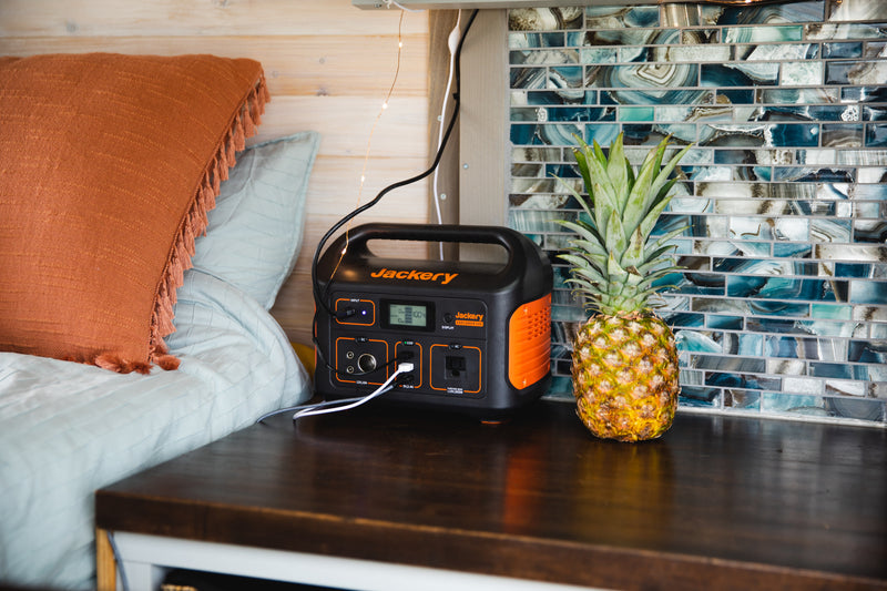 RV rental setup: A Jackery Explorer 500 portable power station sits by a pineapple, charging devices in a cozy space. — photo 13