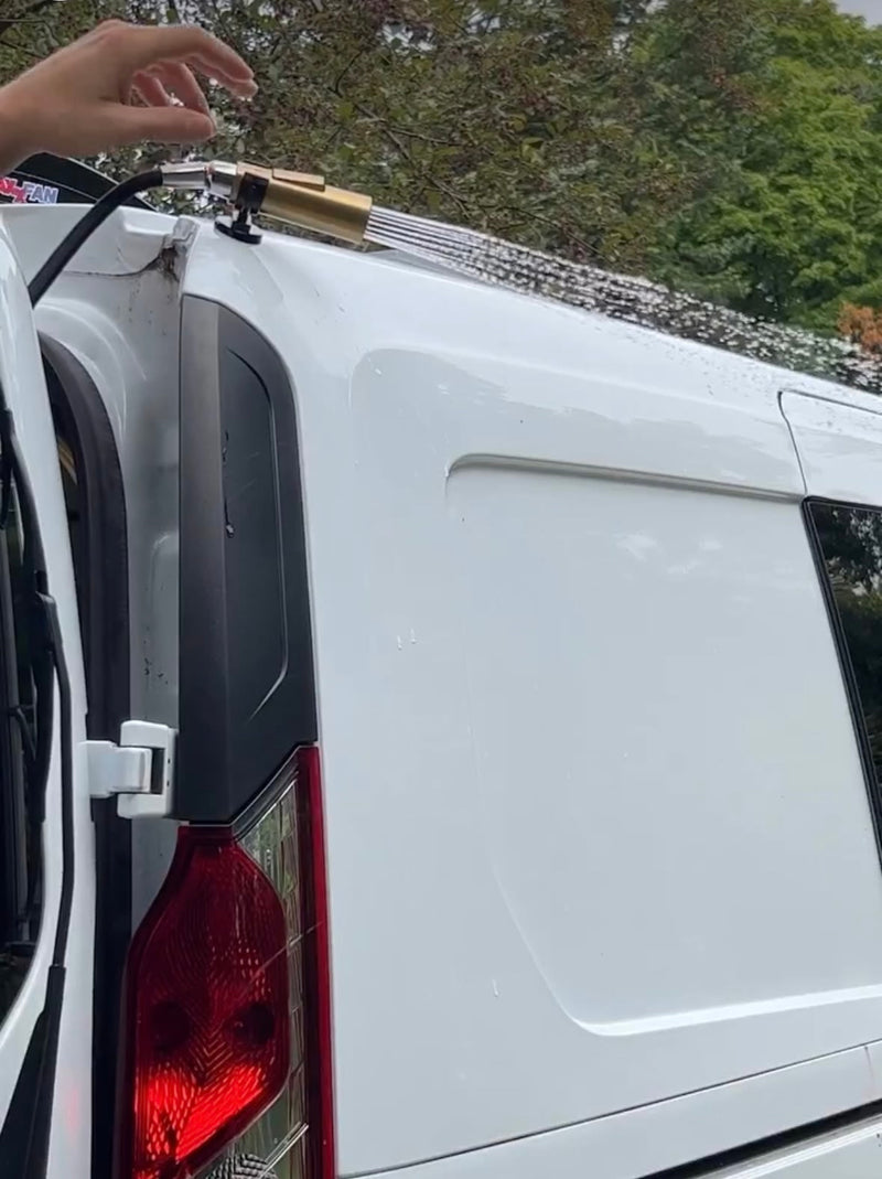  and a portable JBL speaker.|A white RV rental van parked on a scenic mountain road with misty — photo 6