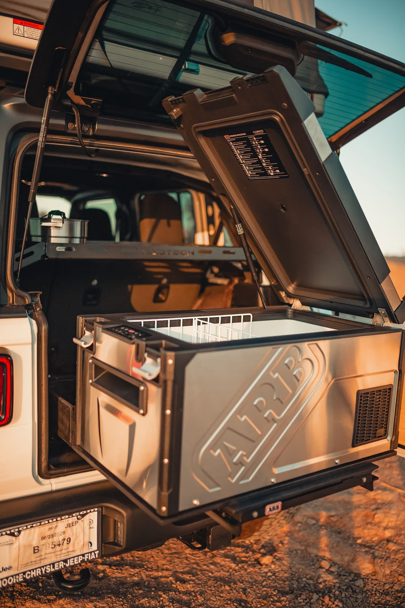 An RV rental Jeep's trunk open, revealing a slide-out ARB fridge/freezer, ideal for off-road camping trips. — photo 6