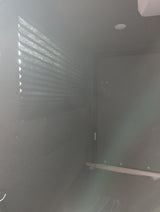 Inside an RV rental: View of a bright window with pleated blinds, recessed ceiling light, and dark, textured interior.
