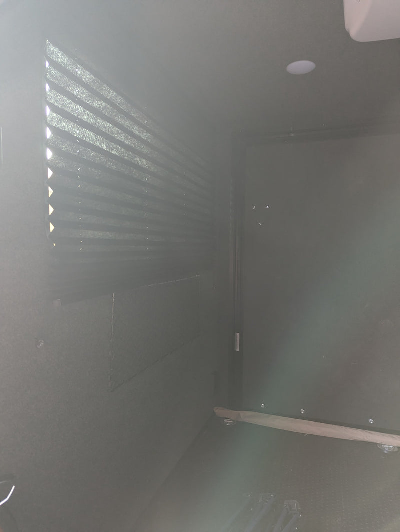 Inside an RV rental: View of a bright window with pleated blinds, recessed ceiling light, and dark, textured interior. — photo 7