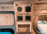 RV rental wood-paneled control panel: Victron battery monitor (79.8%), water pump, heater, and light switches.