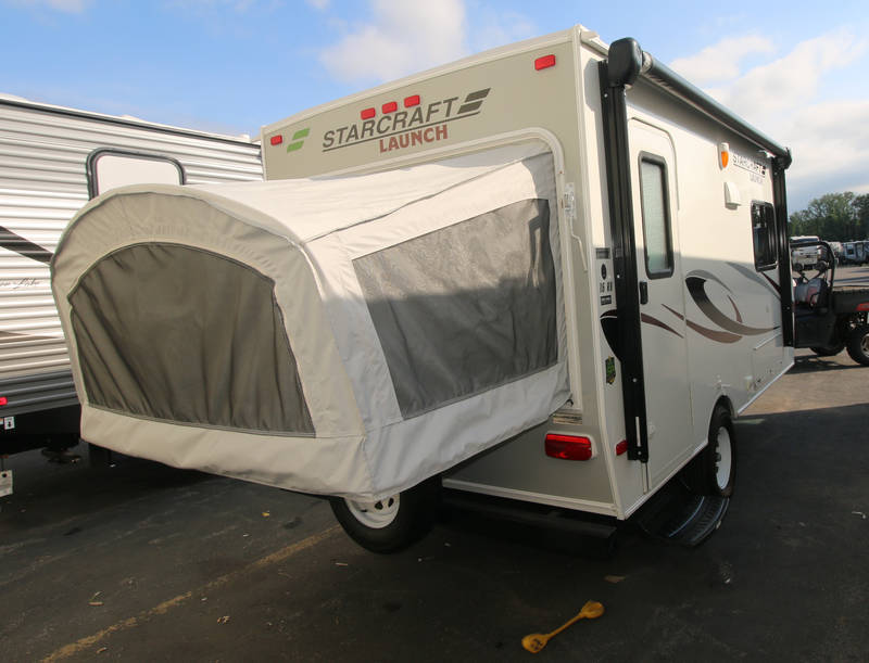 This Starcraft Launch hybrid RV rental features a rear pop-out tent, awning, and side graphics for outdoor adventures.