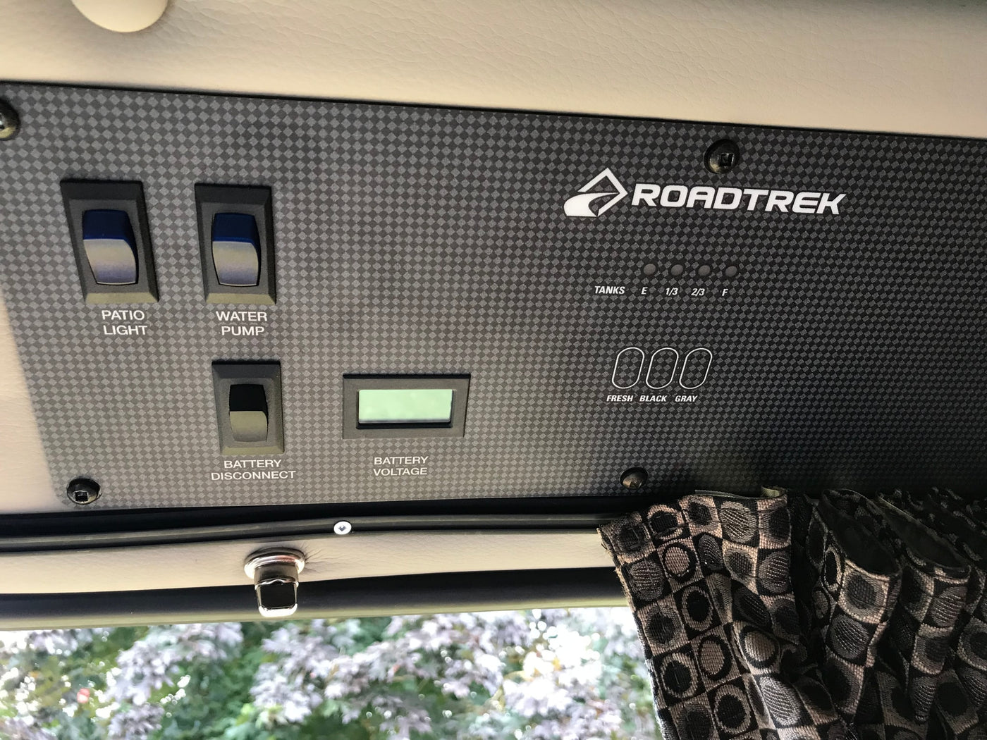  near signs for KOA amenities.|RV rental control panel: Switches for patio light — photo 7