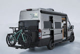 "Rolling Faith" custom camper van RV rental with bikes on back, side door open. Ideal for off-road travel and adventure.