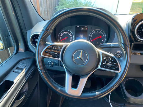Inside an RV rental: Mercedes-Benz Sprinter dashboard with steering wheel controls, gauges, and digital display showing 51079 miles.