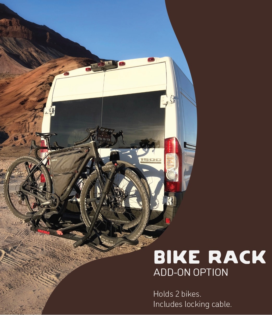 An RV rental parked in a desert landscape, equipped with a bike rack holding two bikes for your adventure. — photo 16