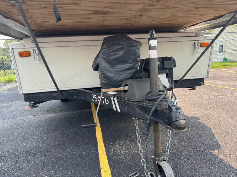  and bed area for your adventures.|Compact RV rental kitchen with a black three-burner Suburban stove — photo 16