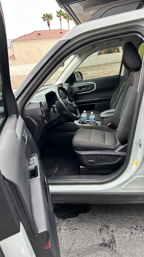 Ford Bronco Sport SUV interior: driver's view, comfy seats, waters. Great comfort for road trips or any rv rental alternative.