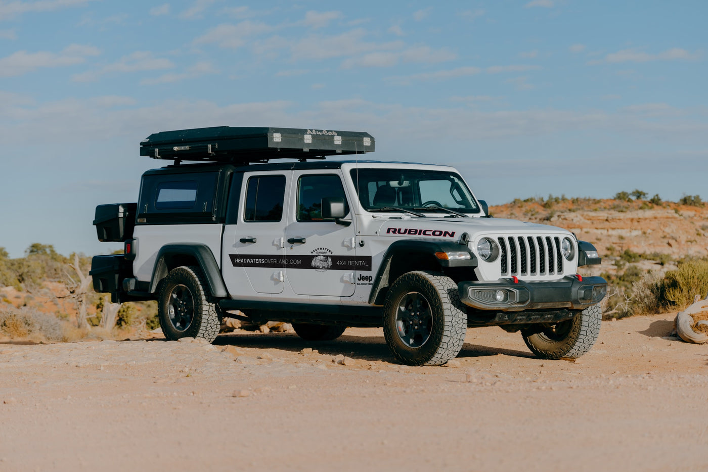 White Jeep Gladiator 4x4 with rooftop tent, ideal for an off-road RV rental adventure from Headwaters Overland. — photo 6