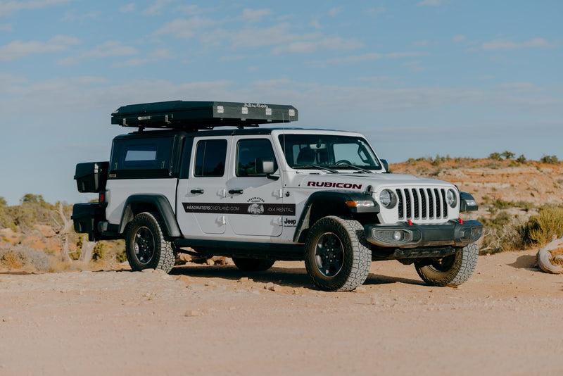 White Jeep Gladiator 4x4 with rooftop tent, ideal for an off-road RV rental adventure from Headwaters Overland. — photo 6