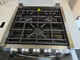 Three-burner gas stove with black grates and control knobs in an rv rental kitchen. Ideal for convenient travel cooking.