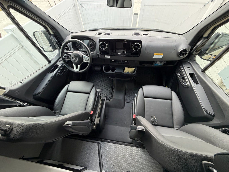 Mercedes-Benz rv rental van's clean front cabin view: dashboard, steering wheel, and black leather seats with keys. — photo 4