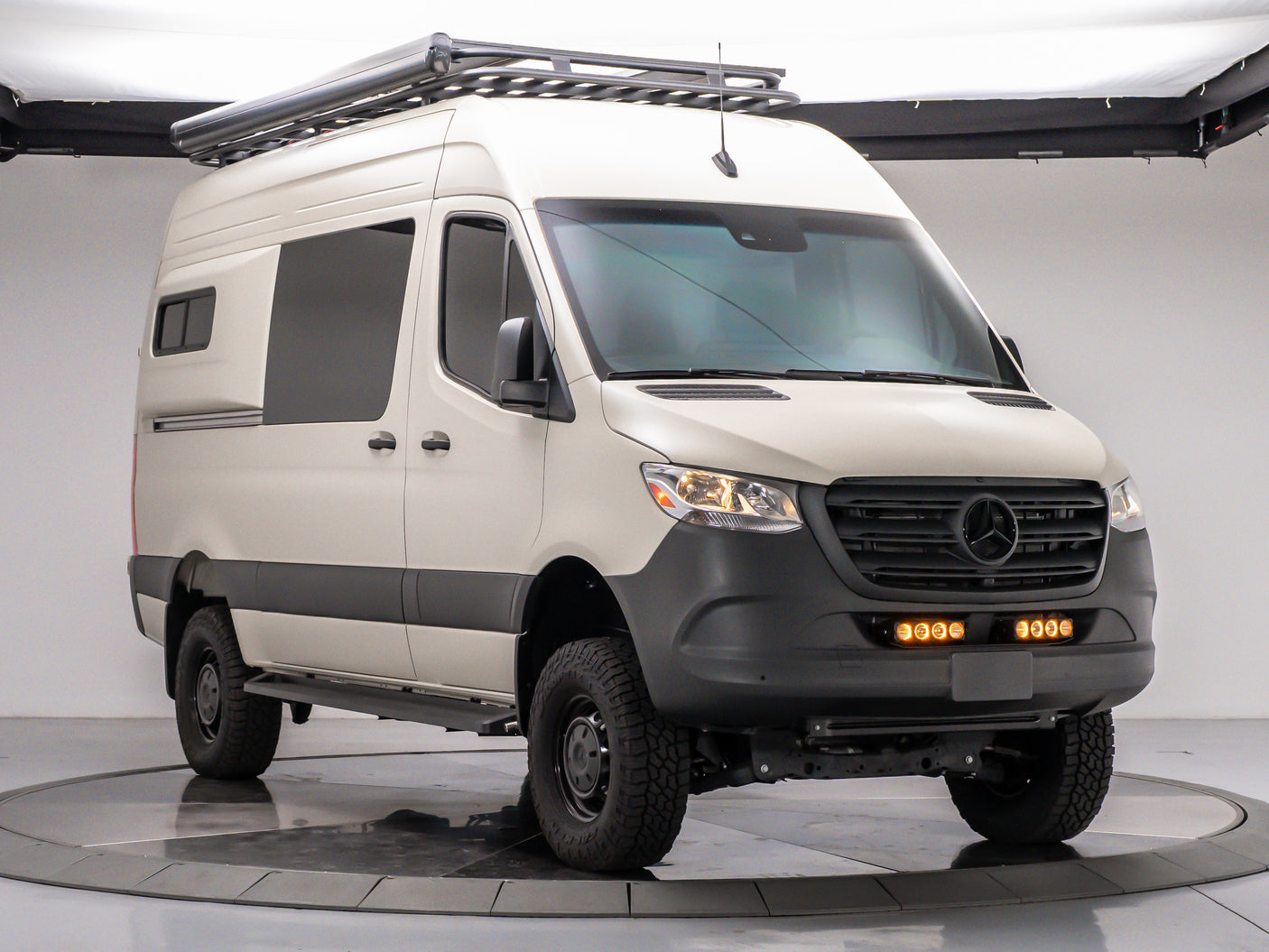 This custom Mercedes Sprinter van, ready for adventure, is an ideal rv rental. Features off-road tires, roof rack & awning.