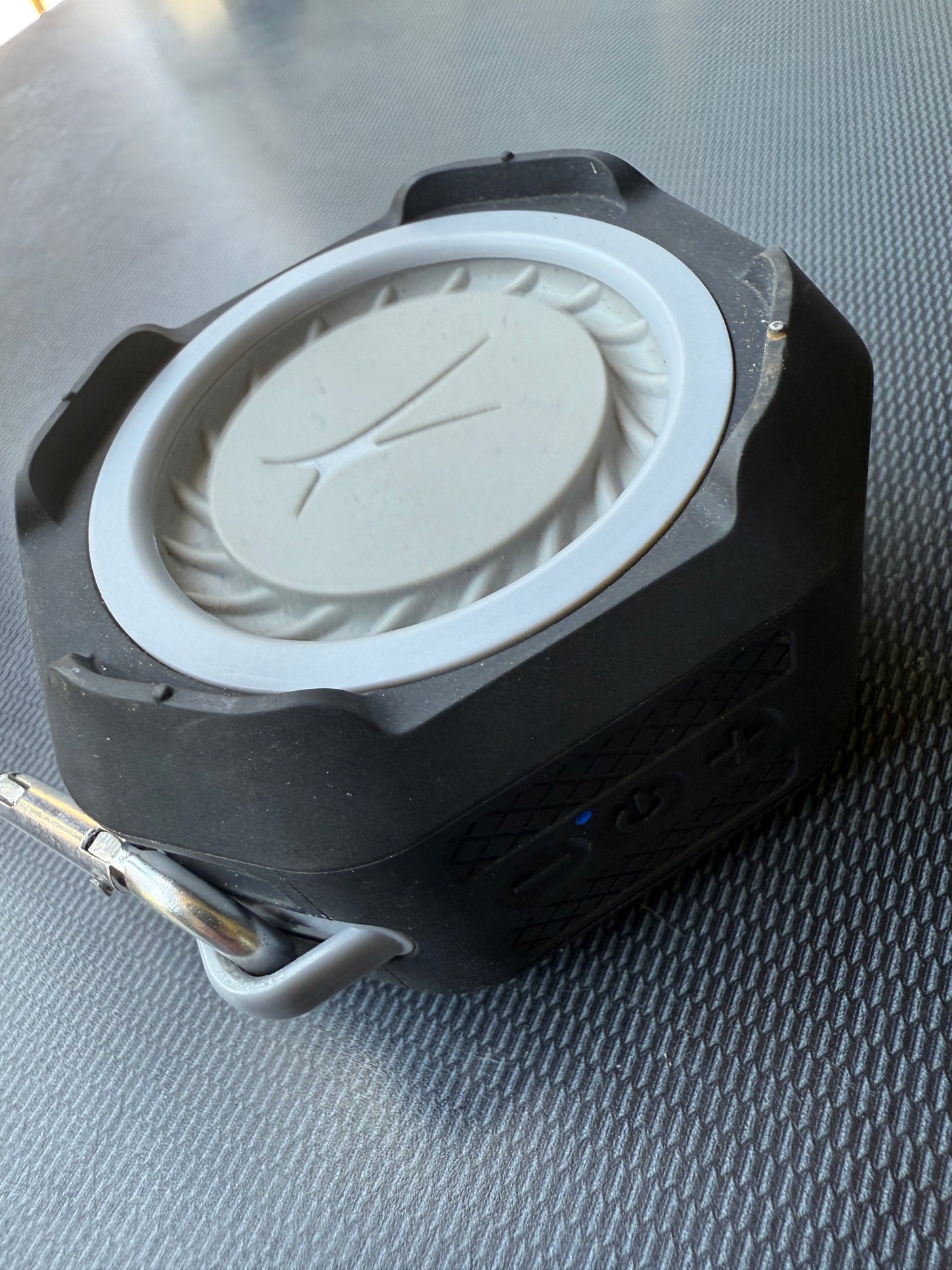 Black, rugged portable speaker with carabiner. Ideal for enjoying music during your next RV rental road trip.