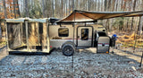 Modern teardrop RV rental camper with screen room & awning at a gravel campsite, ready for adventure.