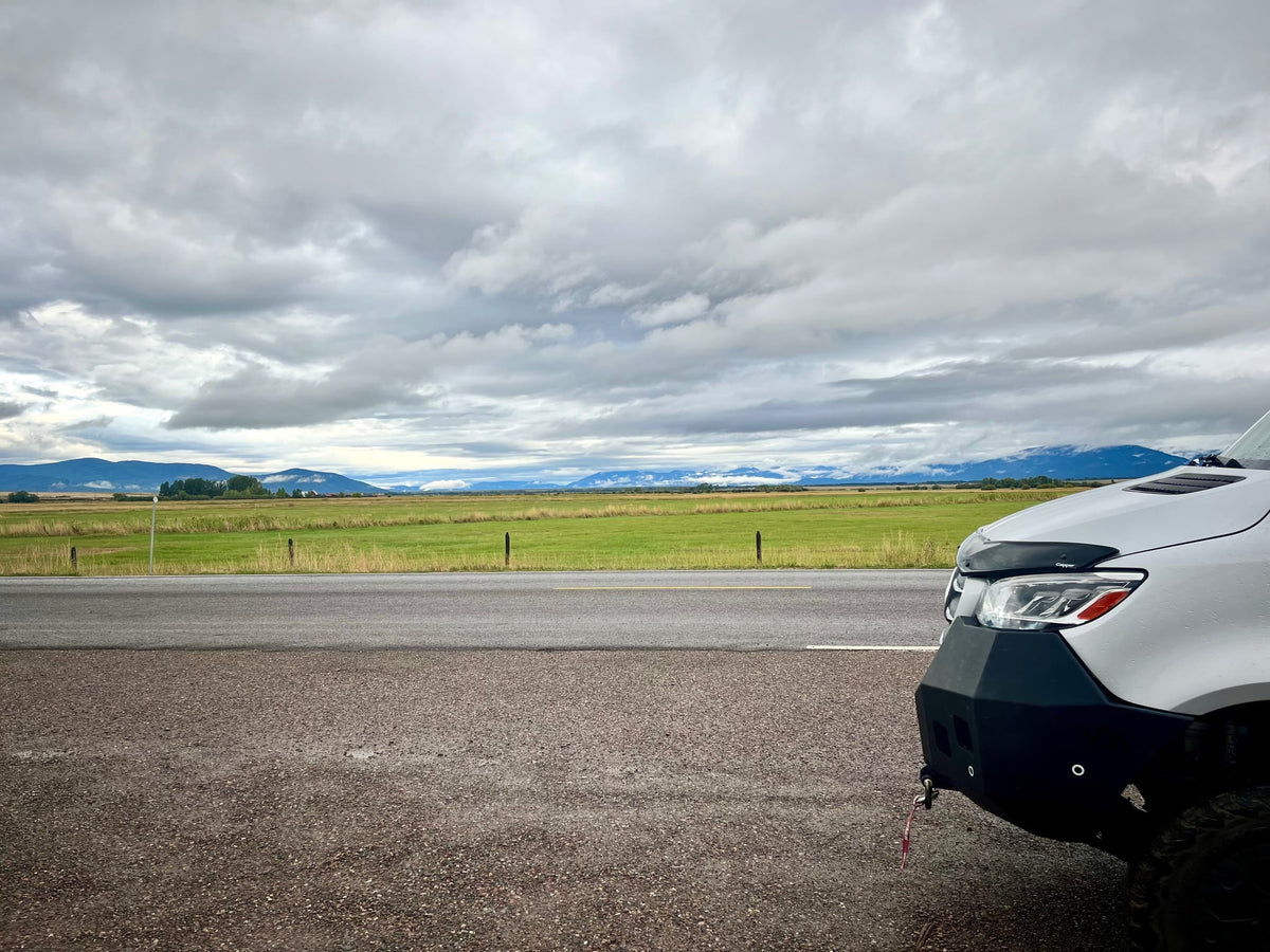  parked in a forest.|RV rental view: Golden sun over a serene lake — photo 8