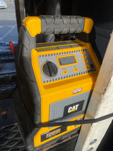 Yellow & black CAT portable power station with digital display (12.7V), jump starter, air compressor, USB, and AC power for your RV rental.
