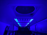 Immerse in the vibrant blue glow of this RV rental's interior. Featuring ambient ceiling lights, a roof vent, and practical overhead storage.