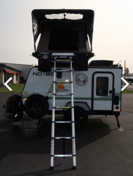 Compact travel trailer RV rental with open rooftop tent & ladder, ready for your next outdoor adventure.