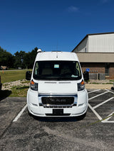 White Ram ProMaster camper van, an RV rental, parked on asphalt on a sunny day.
