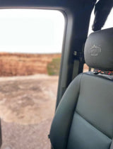 Inside an RV rental, looking out at the vast overland landscape. Storyteller Overland seat visible.
