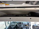 RV rental camper van interior, featuring the pop-top sleeping roof with safety warnings & the driver's cabin with dashboard controls.