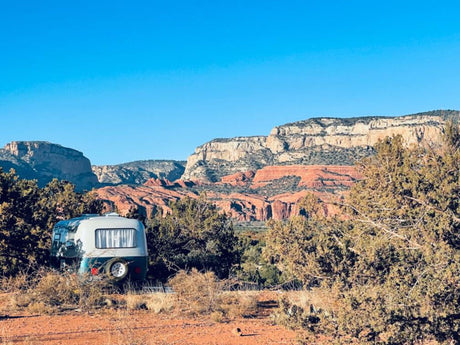 An RV rental provides a cozy base for exploring majestic red rock scenery and desert landscapes.