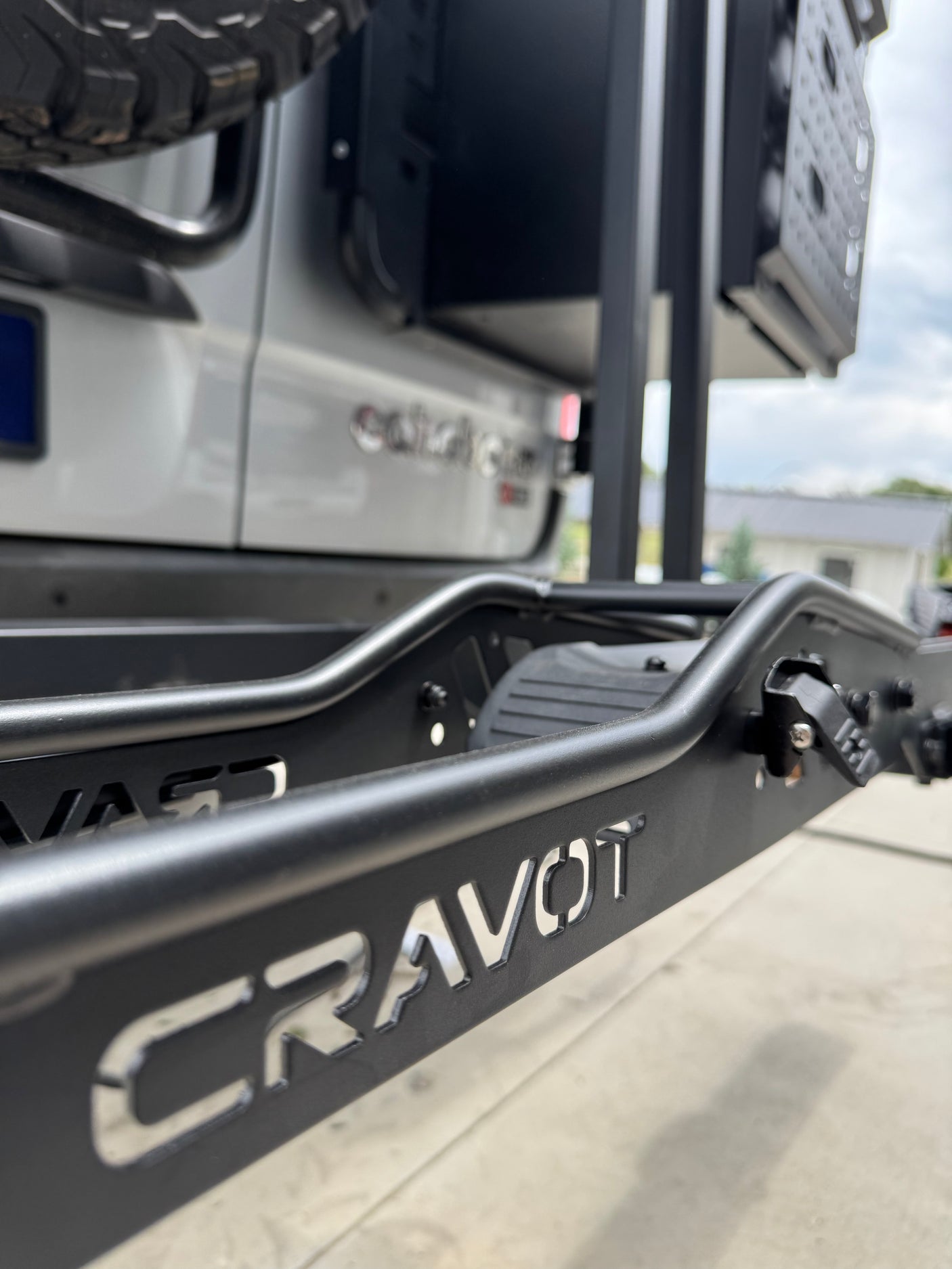 Close-up of a CRAVOT rear rack on a white RV rental, showing durable vehicle accessory for adventure.