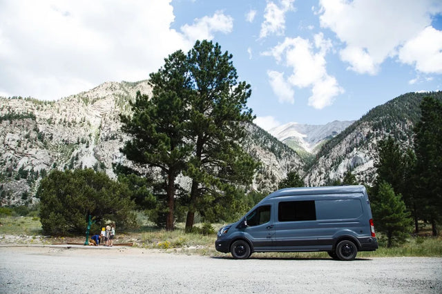  with people and trees around.|RV rental: A grey camper van