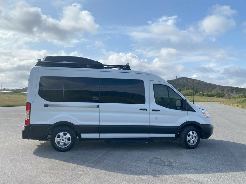 White Ford Transit camper van, equipped for travel, seen from the side, a perfect RV rental option. — photo 17
