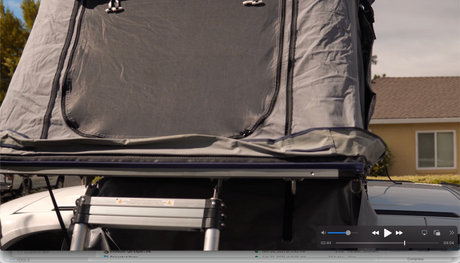 Rooftop tent deployed on a vehicle, offering a compact camping experience, an alternative to traditional RV rental.