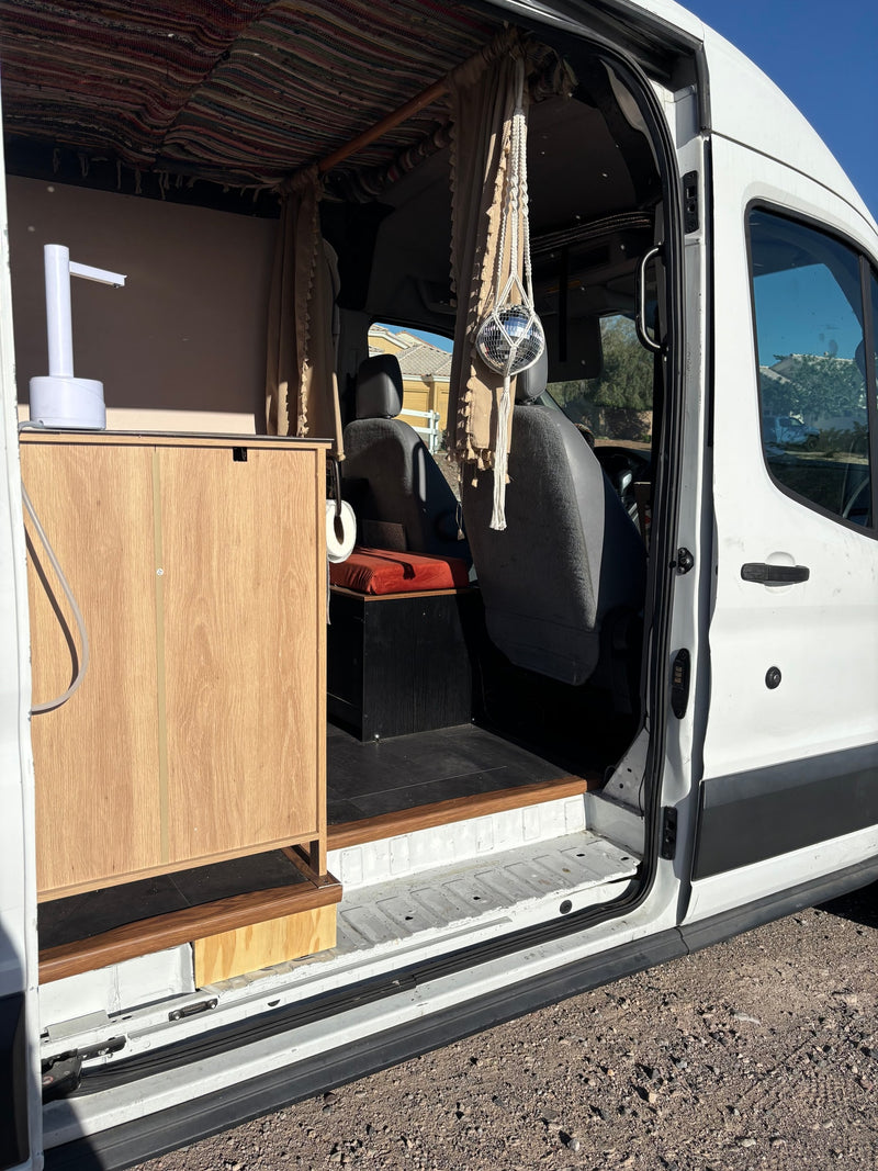 View inside an rv rental camper van: custom kitchenette, patterned ceiling, & a fun disco ball near the driver's seat. — photo 6