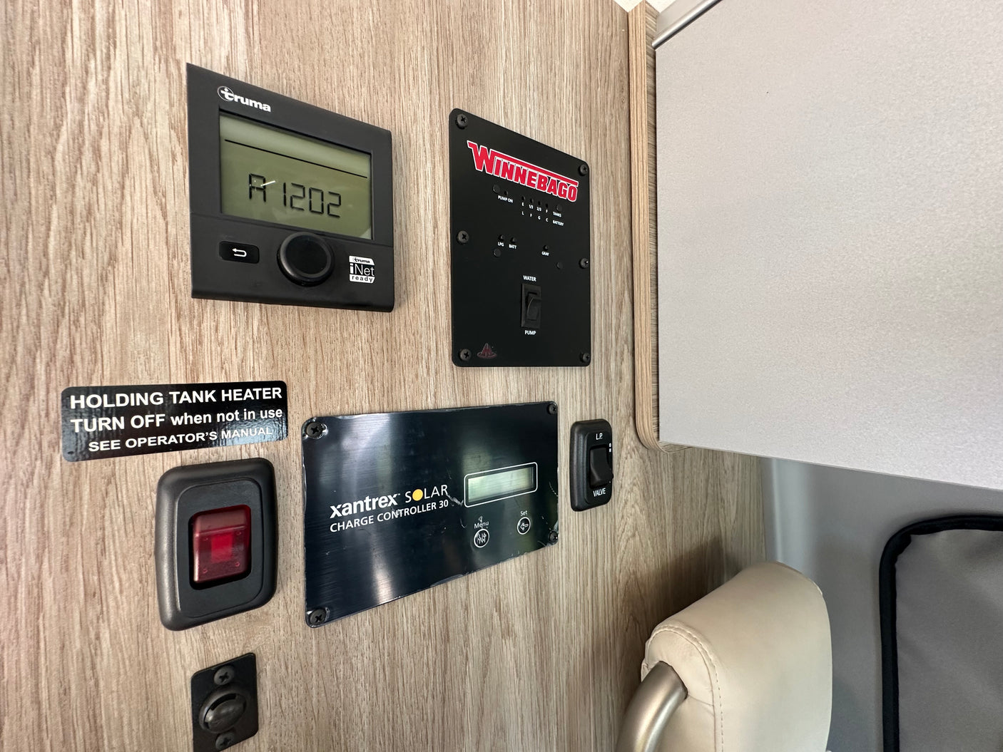 RV rental control panel: Truma, Winnebago tank, and Xantrex solar systems. Manage heat, water, and power.