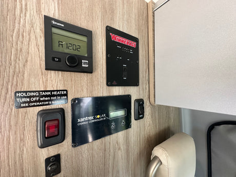 RV rental control panel: Truma, Winnebago tank, and Xantrex solar systems. Manage heat, water, and power.