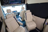 Spacious RV rental interior with luxurious cream quilted leather passenger seats, entertainment screen, and window blinds.