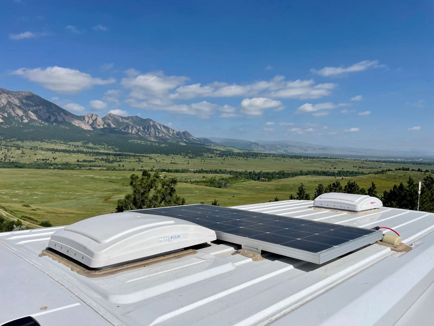  framed by majestic mountains and a blue sky. Ideal for accessible adventures.|Enjoy this stunning mountain view from an RV rental. Features a solar panel & roof vents — photo 5