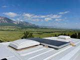 Enjoy this stunning mountain view from an RV rental. Features a solar panel & roof vents, ready for scenic vanlife adventures.