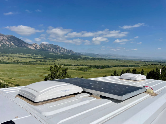 Enjoy this stunning mountain view from an RV rental. Features a solar panel & roof vents, ready for scenic vanlife adventures.